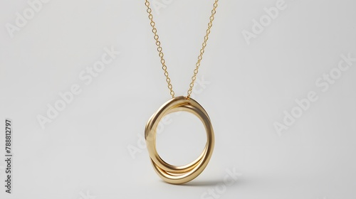 A minimalist gold necklace consisting of a single perfectly formed loop capturing the essence of elegance in its simplicity The necklace hangs against a stark white background