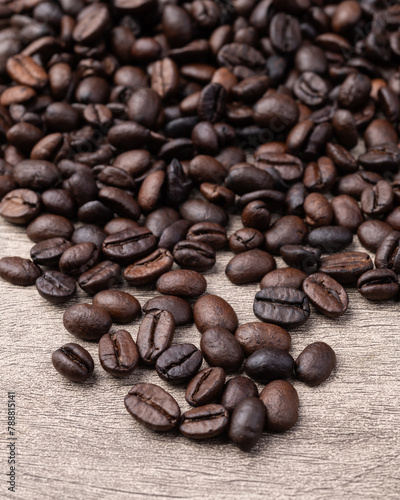 Closeup of coffee beans over rustic wooden table