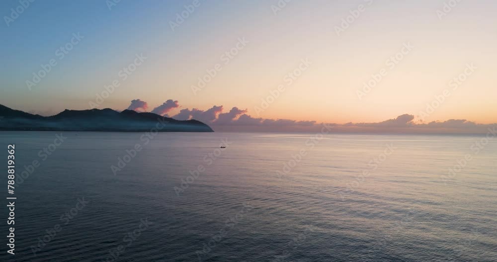 boat crossing the ocean at sunrise by Calla Minor at Mallorca boat crossing the ocean at sunrise by Calla Minor at Mallorca