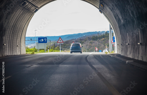 Vehicle coming out of a tunnel on a highway