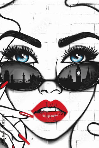 An illustration depicts a woman's face with distinguishing features such as large blue eyes and vivid red lips. She is wearing sunglasses that interestingly mirror the famous London skyline which... photo