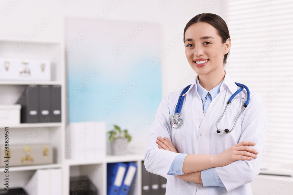 Medical consultant with stethoscope in clinic, space for text Medical consultant with stethoscope in clinic, space for text