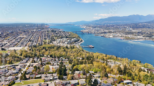 Beautiful aerial view of the skyline of Vancouver and North Burnaby next to the Burrard Inlet during a spring season in British Columbia, Canada