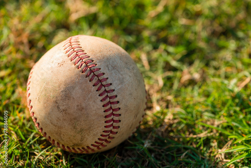 Close up of well worn baseball on grass © Eric Hood