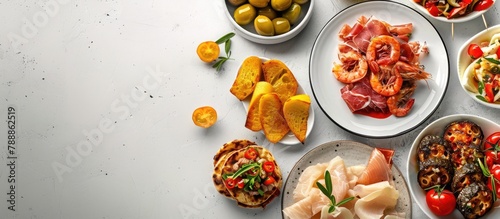 Spanish tapas placed on a white table in a traditional manner, photographed from above with empty space for text.