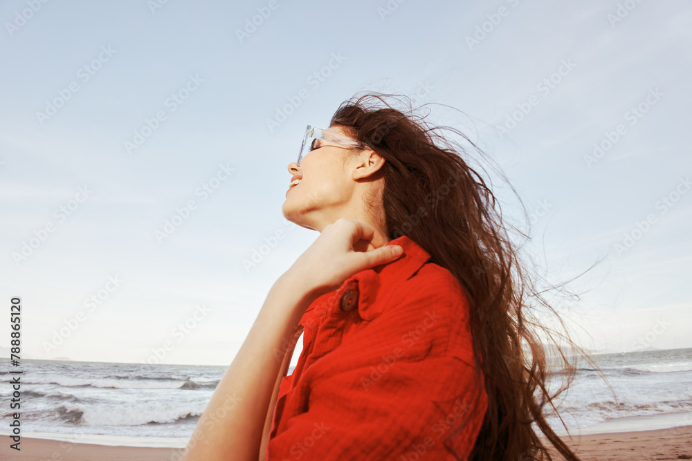 Sunny Beach Adventure: Portrait of a Smiling Woman with Sunglasses, Embracing Freedom and Joy in Colorful Trendy Clothing, against a Wide Angle Beach Background. Sunny Beach Adventure: Portrait of a Smiling Woman with Sunglasses, Embracing Freedom and Joy in Colorful Trendy Clothing, against a Wide Angle Beach Background.