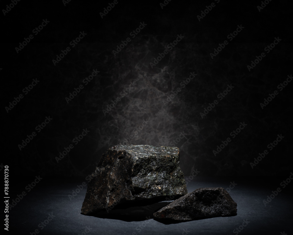 Naklejka premium natural stones on a dark background for the podium