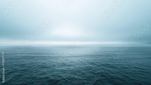 Peaceful ocean expanse under overcast skies in soothing shades photo