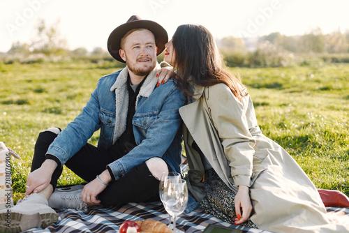 Stylish couple have a picnic on a nature and hugging