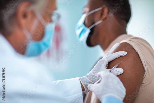 Healthcare worker administering vaccine to patient photo