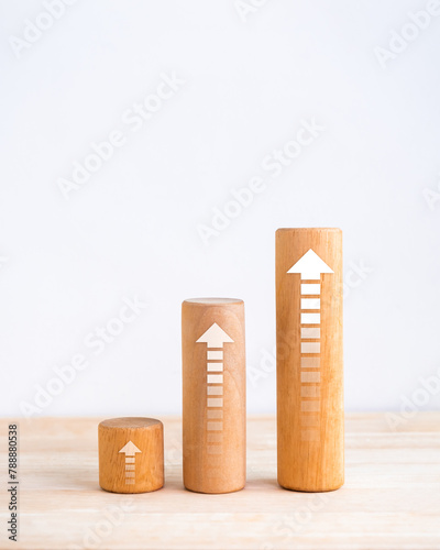 Arrows upward on cylindrical wooden bar graph steps isolated on white background, vertical style, business growth process, profit planning, success investment goal chart, growing market concepts.