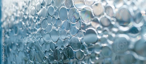 A close-up view of a window with a multitude of bubbles spread across its surface, creating a unique and abstract pattern