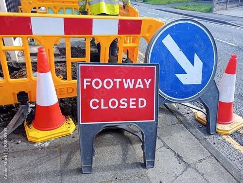 Footway closed sign in front of barrier with white arrow sign.  19-04-2024, Lancashire, UK