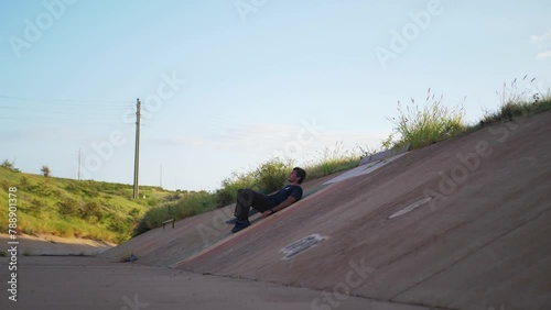 Person lays in a ditch the ground from exaustion photo