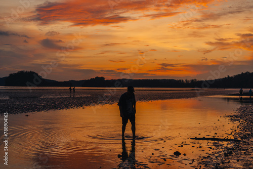 Silhouette of woman on calm beach and sky Evening at Ao Nang  Krabi