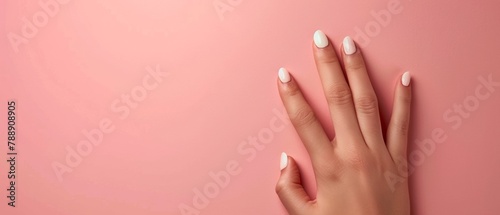 Elegant Female Hand Displaying French Tips Nail Design Against Pastel Background