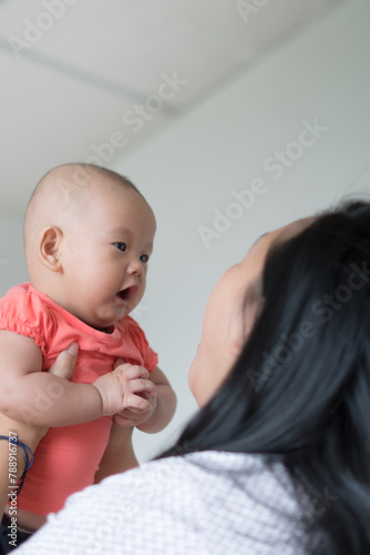 Asian mother holding her infant girl