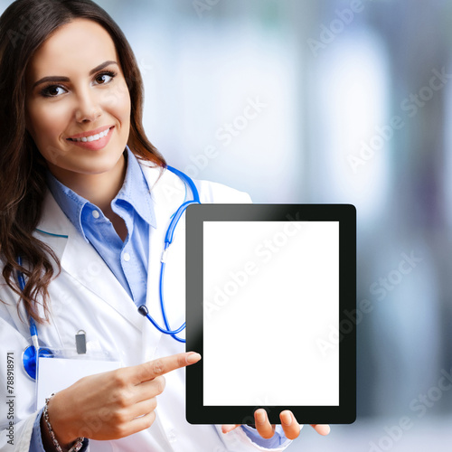 Portrait of happy smiling female doctor show tablet pc with blank copy space area for slogan or text, against blurred modern office background. Medical call center concept. Square image