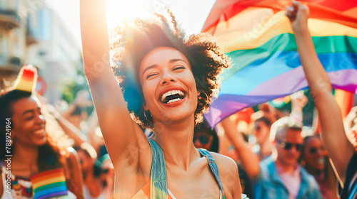 Happy smiling of young trendy beautiful black ethnic female teen face raise hand up with rainbow LGBTQ flag in pride month festival. Pride day, celebration carnival parade, lesbian free women concept.