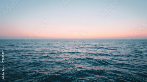 Minimalist sunrise over a calm ocean with a subtle gradient sky and a hint of light on the water