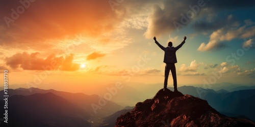 Raising arms on top of mountain with blue sky and sunlight The concept of being a successful leader with goals, growth, and upwards. photo