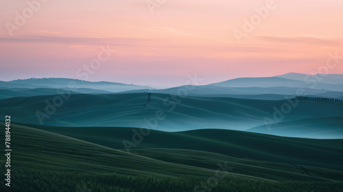 A simple view of rolling hills under a pastel sunset