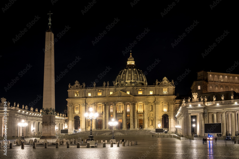 Nighttime vista of Saint Peter's Square in Vatican City, the papal enclave in Rome, showcasing the iconic Vatican obelisk at its center, framed by the striking backdrop of St. Peter's Basilica.