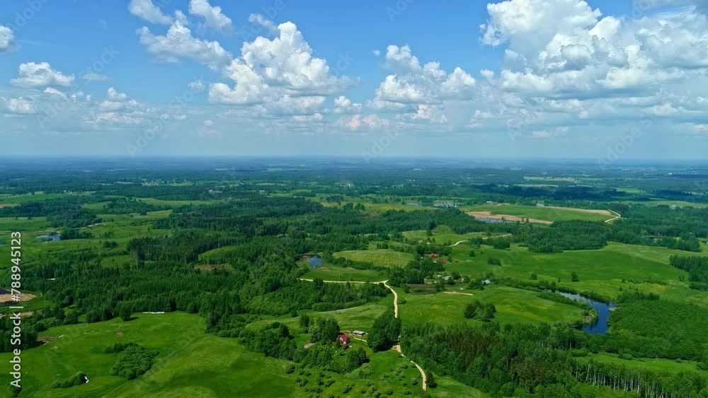 Lush Green Landscape And Blue Sky In Daytime. - aerial shot Lush Green Landscape And Blue Sky In Daytime. - aerial shot