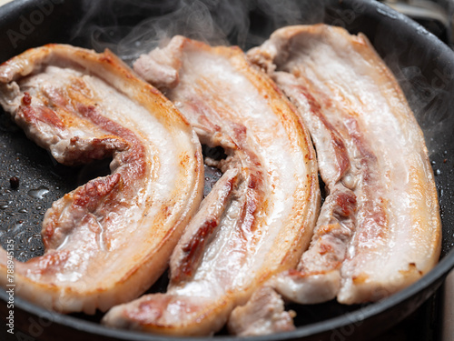 Pork belly grilled in an iron pan photo