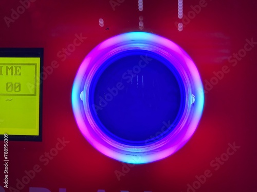 Glowing button and console on an arcade game