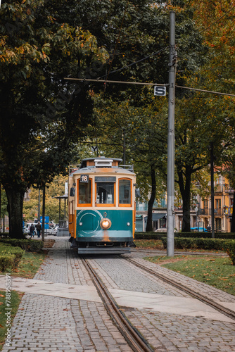 Street view with the famous retro tourist streetcar tram in the old town of Porto, Portugal. Traditional Tram