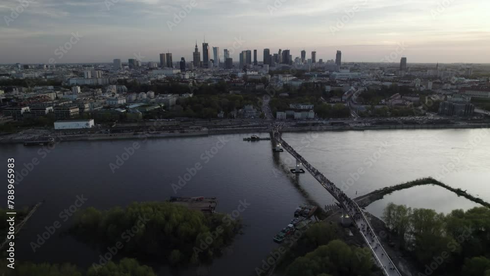 Aerial panning view of the Agrafka bridge with the city skyline of Warsaw in the backdrop. Aerial panning view of the Agrafka bridge with the city skyline of Warsaw in the backdrop.