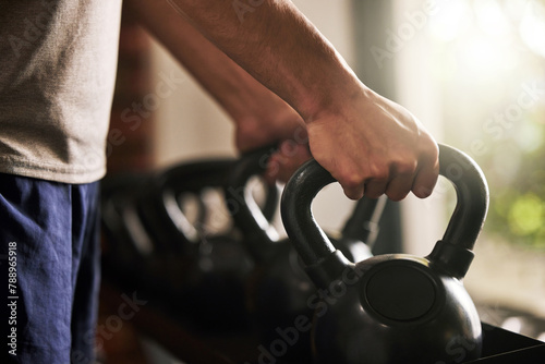 Kettlebell, hands and training in gym, fitness and hard work for body builder, strong and muscle of forearm. Workout, exercise and athlete in club, wellness and balance in sports, person with goal