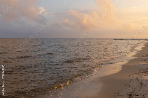A scenic sunset view of a beach on the Gulf of Mexico in Biloxi, Mississippi, United States of America.