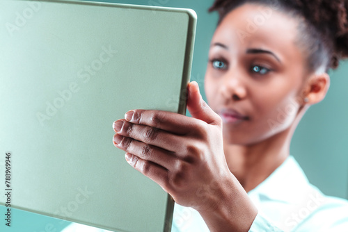 Intense concentration, woman studies tablet, technology adept