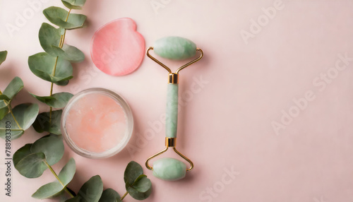 Top view photo of eucalyptus green quartz roller and pink eye patches on isolated pastel pink background with copyspace
 photo