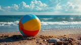 A beautiful shot of a colorful beach ball on the sand on a sea background