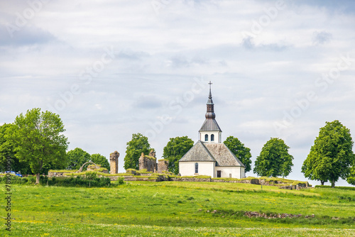 Church with a abbey ruin on a hill in Sweden