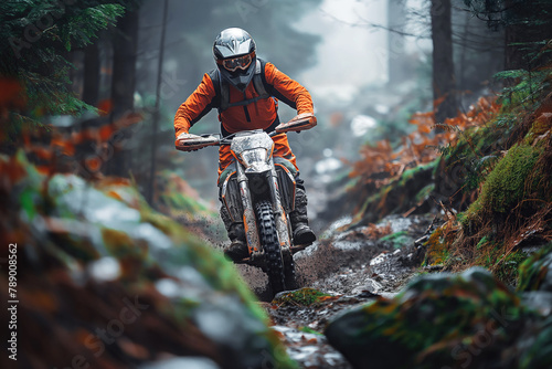 man racer motorcyclist on a sport enduro motorcycle riding in race in forest road in nature