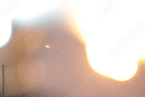 Natural background blurring warm colors and bright sunlight, color orange light patterns plain abstract.