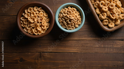 Nuts in a plate on a wooden background. View from above. Place for text, empty space.