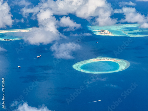 aerial landscape view of the almost round Kuda Giri Reef in Maldives with sand beach, surrounded by deep blue sea  photo