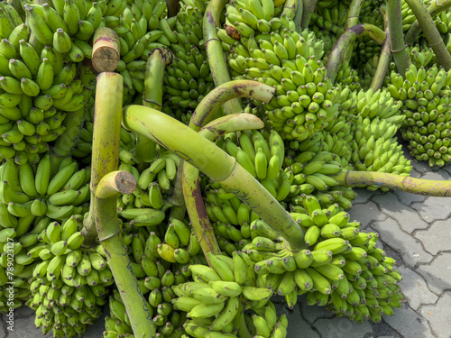 a green bunch of banana on a fruit market - fresh bananas for healthy eating