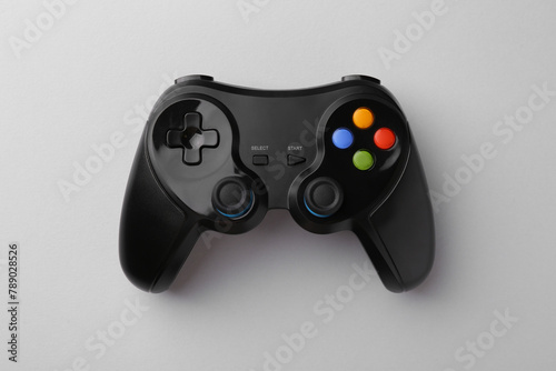 Wireless game controller on light grey background, top view photo