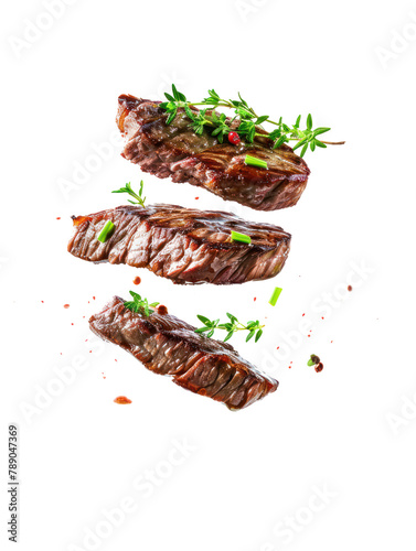 grilled beef steaks levitate above each other with spices and herbs. frontal view. on transparency background PNG photo