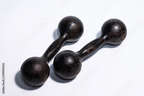 Dumbbells for fitness. Old dumbbells. Dumbbells for sports. Fitness tools. Dumbbells on white background. Old dumbbells.