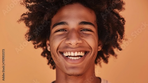 Happy cheerful young African American gen z guy isolated on beige background Smiling funny ethnic teen student cool curly generation z teenager laughing with white perfect teeth close  : Generative AI © Generative AI