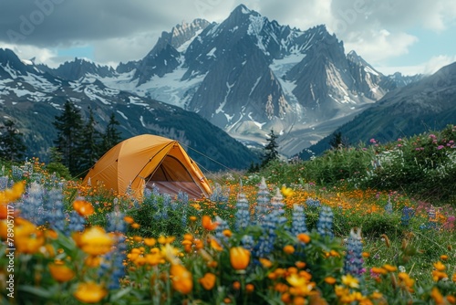 An inviting scene of orange camping tent in a field of colorful wildflowers, with dramatic mountains behind