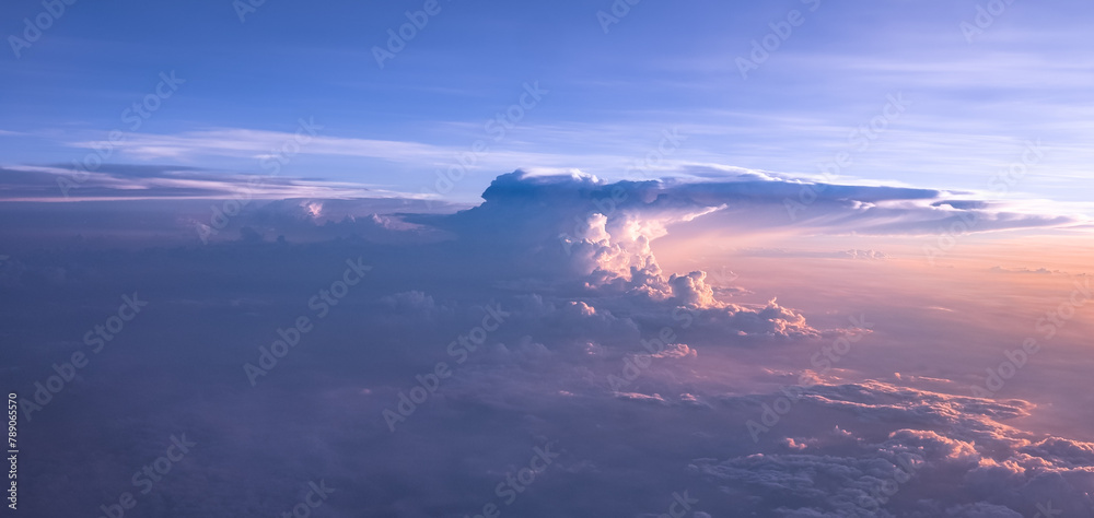 An aerial shot above beautiful sunset, sunrise clouds. Sunset above the clouds from airplane perspective.