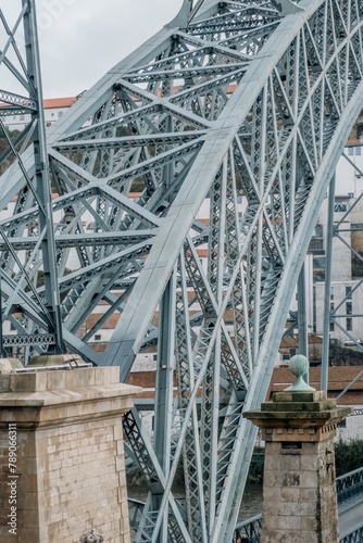 A close-up of the Dom Luís I Bridge in the old town of Ribeira, Porto, Portugal. Fragment of a metal railway bridge between Oporto and Nova Gaia